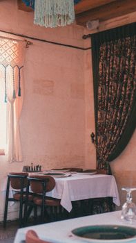 A warm and inviting traditional restaurant corner with vintage decor in Şanlıurfa, Türkiye.