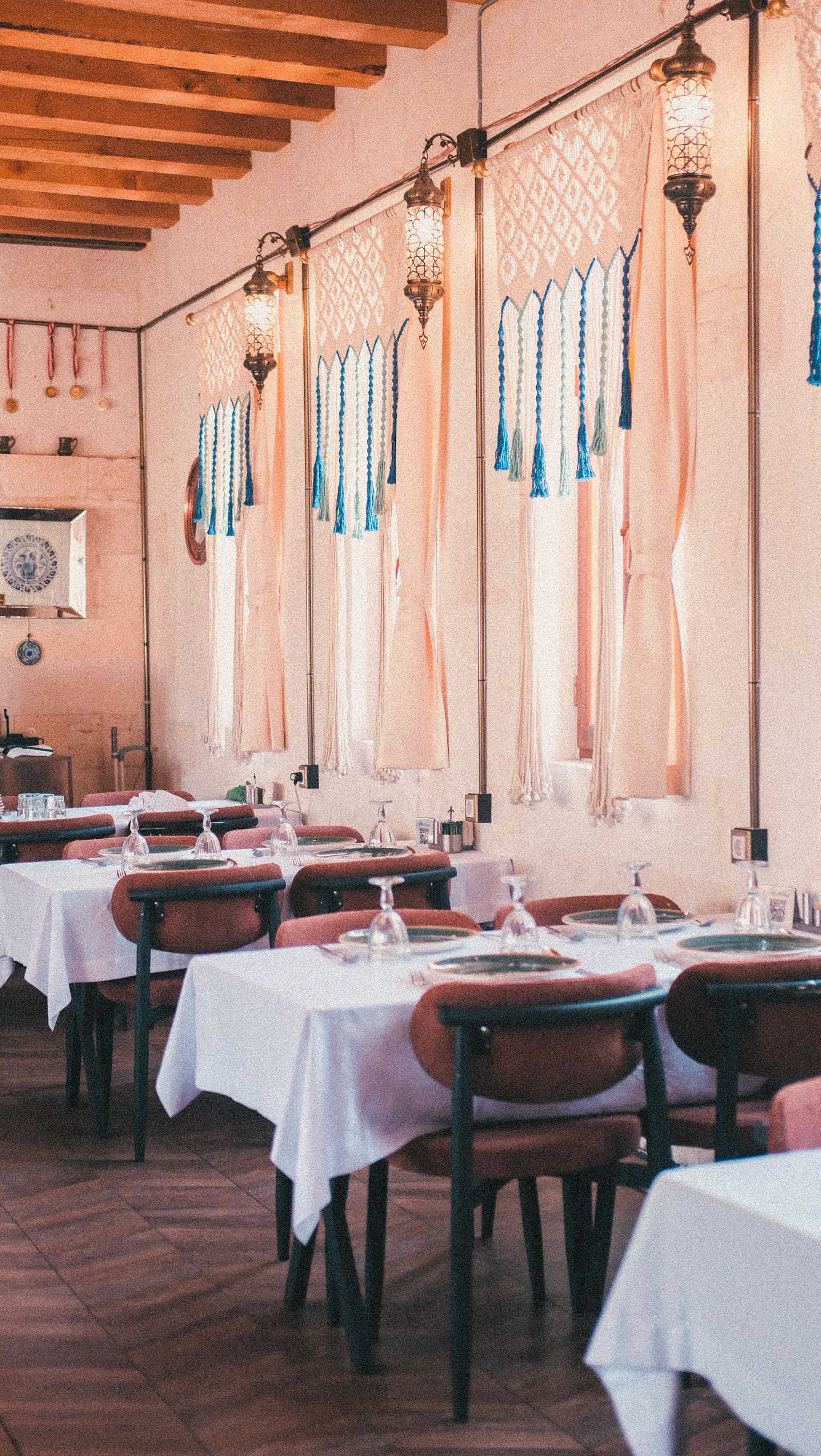 cozy mediterranean restaurant with wooden tables and warm natural light