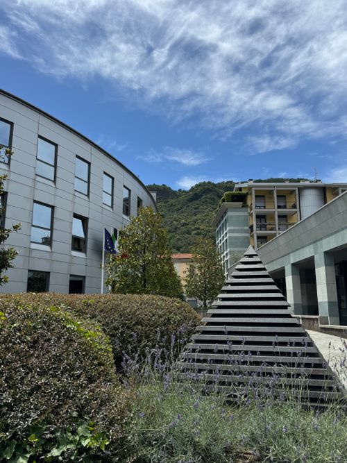 Free Contemporary buildings and pyramid sculpture in Como, Italy under a bright sky. Stock Photo