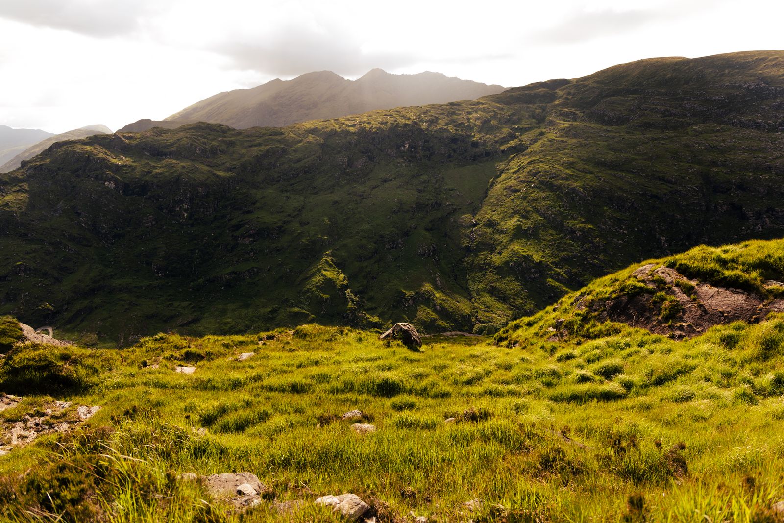 Green hills and mountains in Killarney, Ireland, under a bright sky