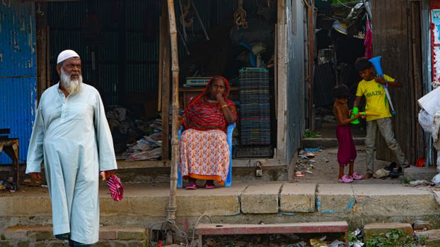 Candid street scene depicting daily life with people of different ages in an urban environment.