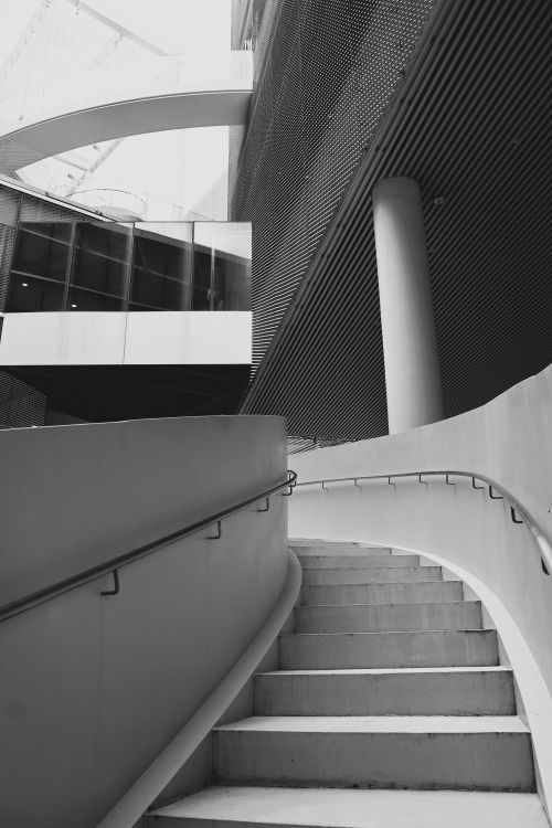 Free Curved staircase in contemporary building showcasing modern architecture in black and white. Stock Photo