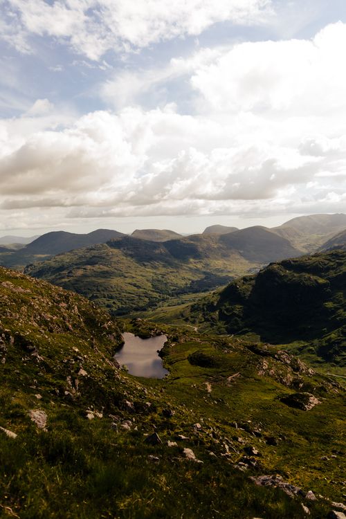 Free Breathtaking landscape of Killarney, Ireland, showcasing rugged mountains and serene valleys under a cloudy sky. Stock Photo