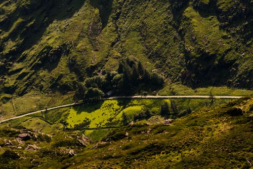 Free Aerial view of lush green hills in Killarney National Park, Ireland, on a sunny day. Stock Photo