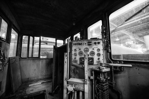 Free Explore the vintage train cockpit interior showcasing control panels and gauges in a monochrome setting. Stock Photo