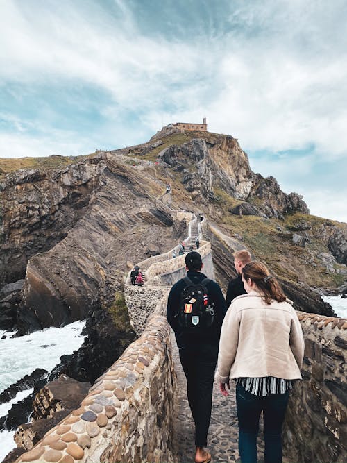 People Walking on Path of Gaztelugatxeko Doniene