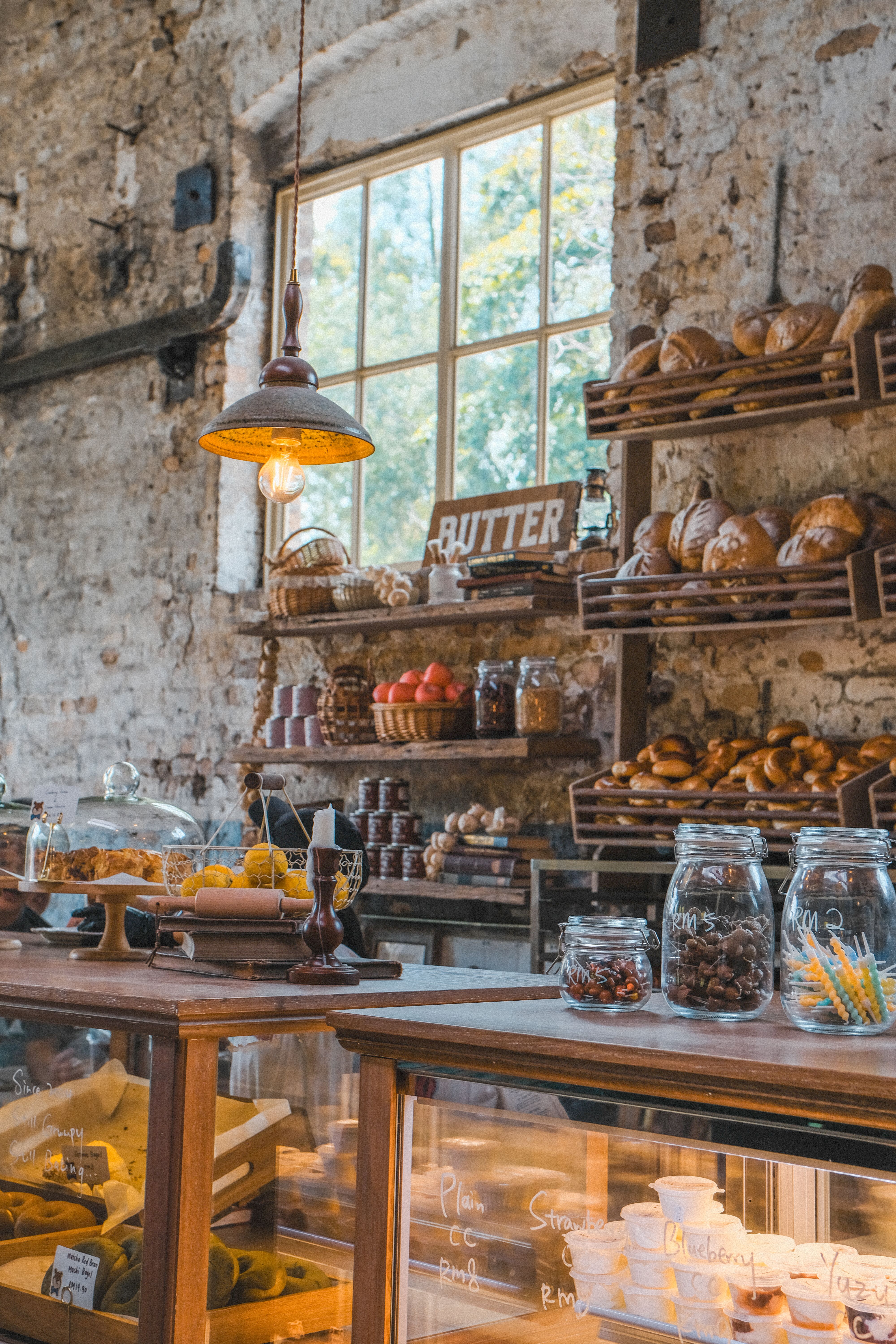 Warm rustic bakery interior with fresh bread and pastries under soft lighting