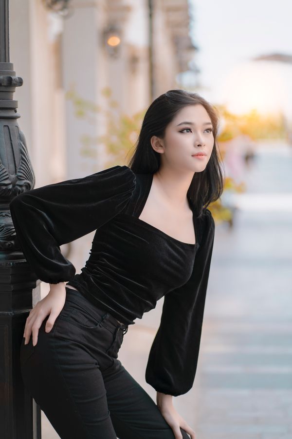 Woman in cropped jeans with a velvet peplum top