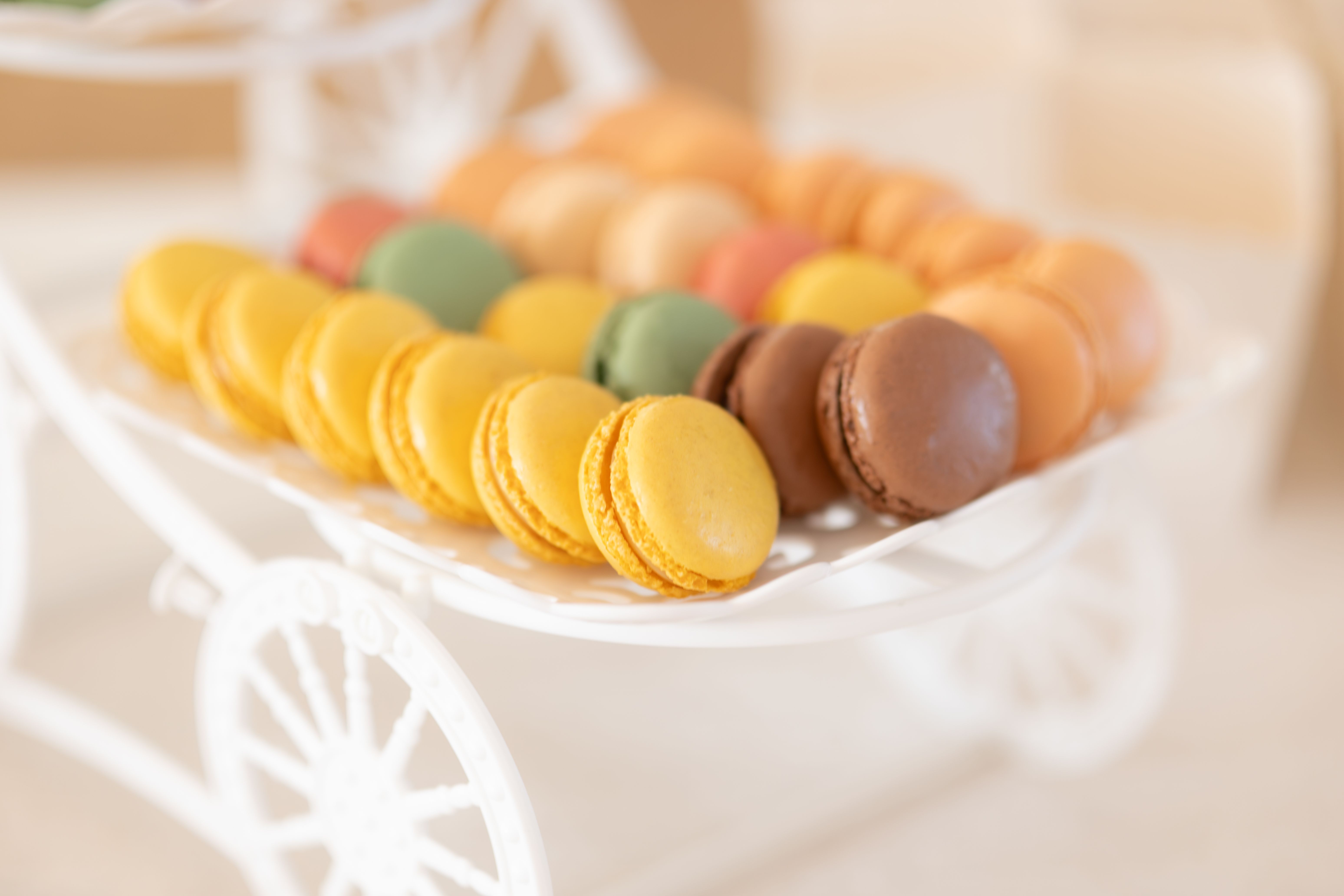 Assorted pastel macarons arranged like jewellery on an elegant white tray