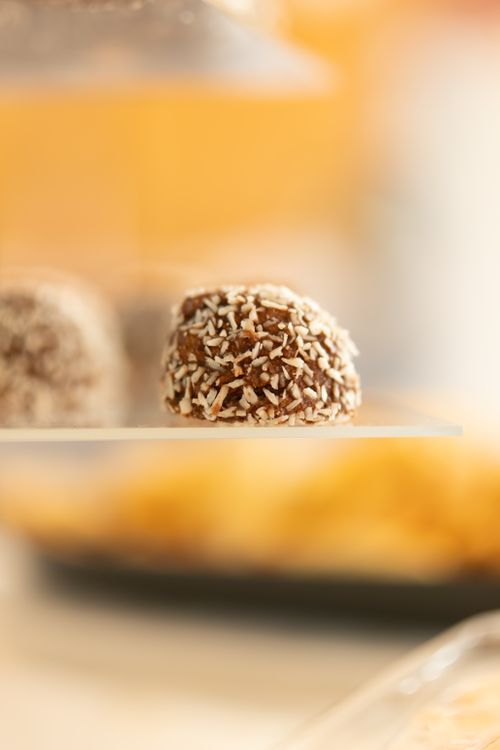 Free Close-up of a chocolate coconut truffle on a glass plate, perfect for dessert inspirations. Stock Photo