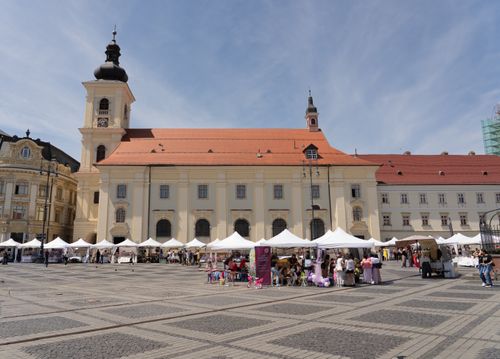 Free A bustling open market on a sunny day at Piața Mare in Sibiu, Romania. Stock Photo