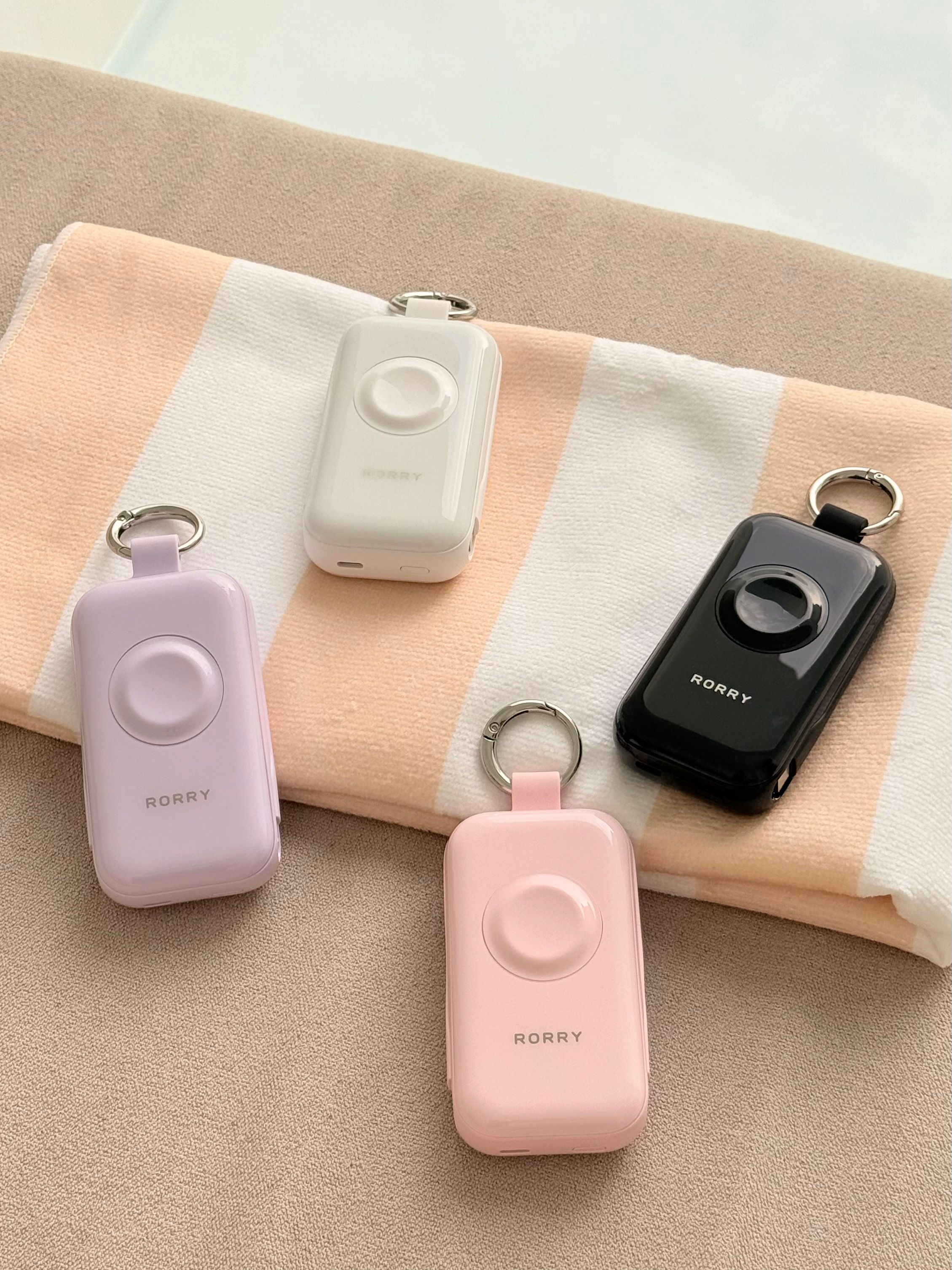 Personal safety alarms in pastel colors on fabric