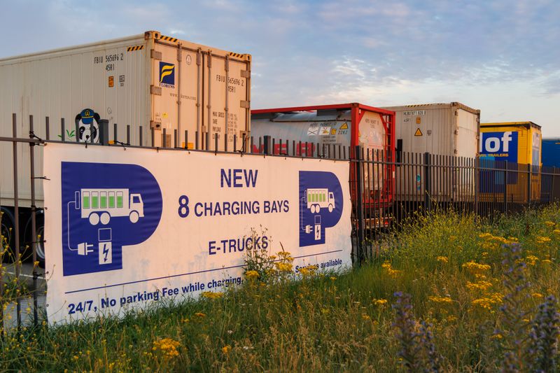 Electric truck charging station at sunset showcasing sustainable transport