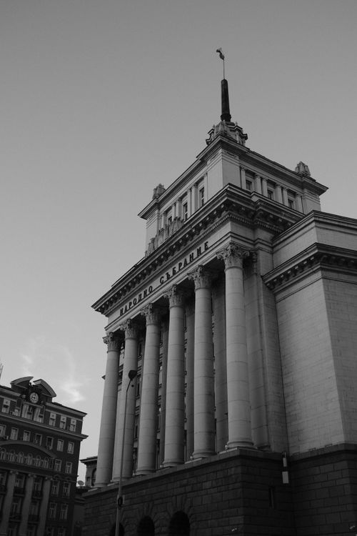 Free Black and white photo of historical building in Sofia, Bulgaria. Elegant architectural design with columns. Stock Photo