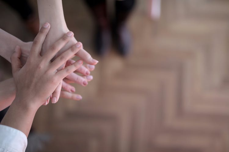 Crop Group Stacking Hands Together