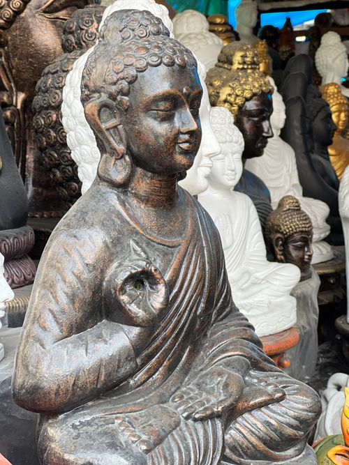 Free Collection of Buddha statues in an Indian market, showcasing various styles and materials. Stock Photo