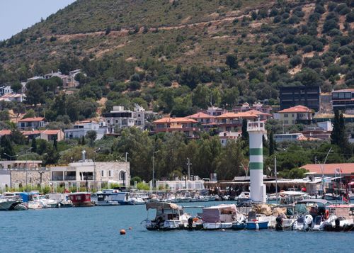 Free Beautiful harbor with boats and lighthouse in Izmir, Türkiye, under clear skies. Stock Photo