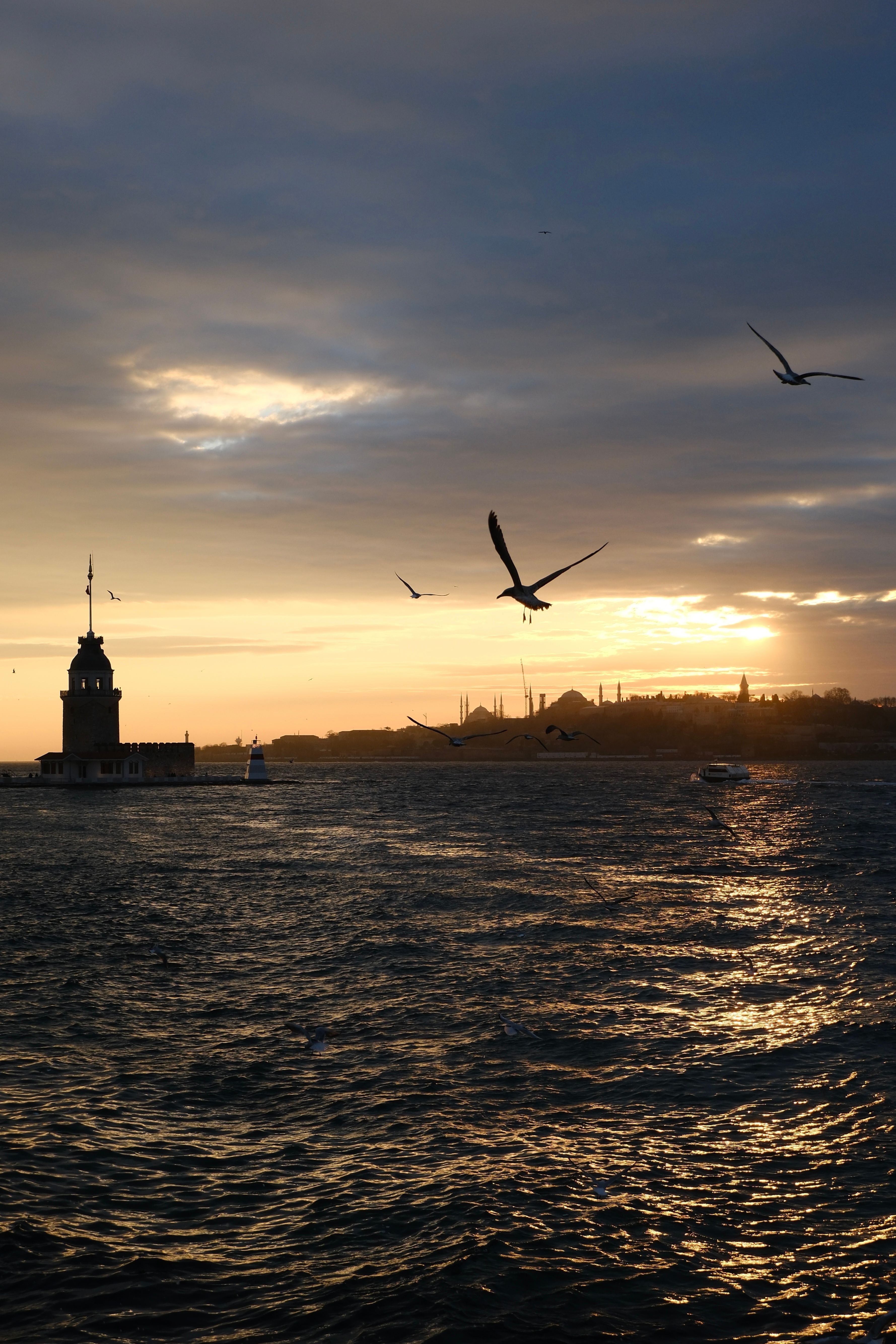 A stunning Istanbul sunset with Maiden's Tower silhouetted against the golden sky.