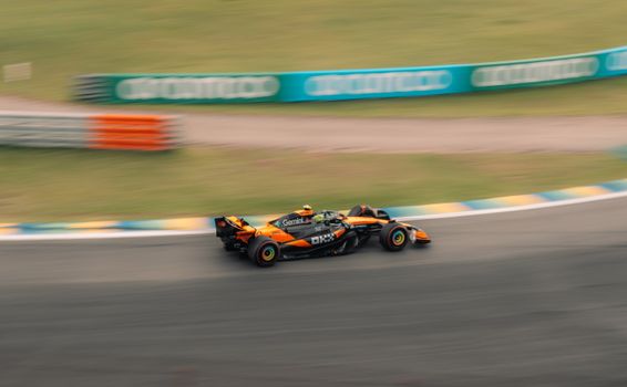 A thrilling capture of a Formula One car speeding on a racetrack in São Paulo.