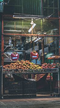 Vibrant fruit display at a Medellín market showcasing fresh produce under warm lighting.