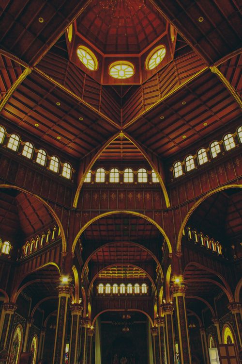 Free Explore the intricate architectural details of a grand cathedral's interior with stunning arches and stained glass. Stock Photo