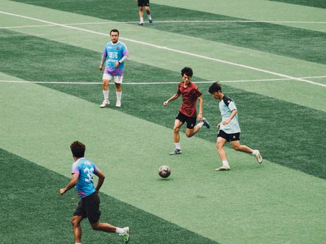 Dynamic soccer game featuring players in colorful jerseys on a vibrant green field.