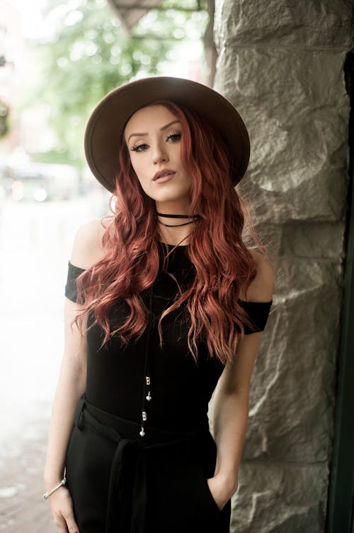 Stylish woman in hat looking at camera