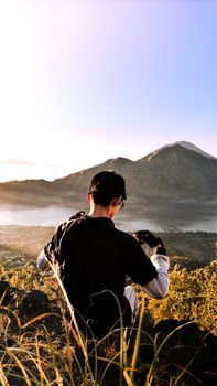 A person enjoying sunrise views over a mountain range, capturing a serene moment in nature.