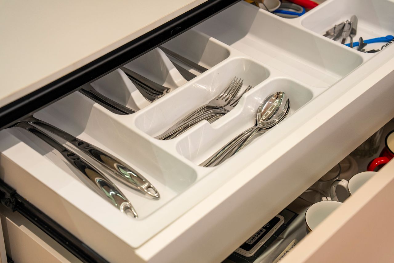 A drawer interior fitted with a cutlery tray