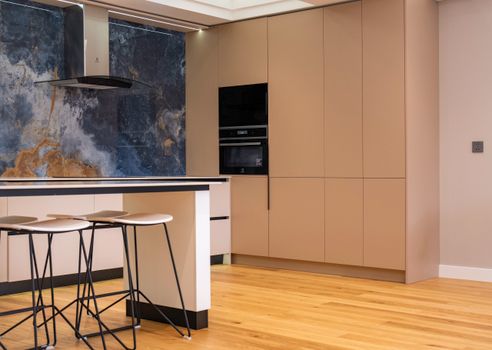 Sophisticated kitchen design featuring minimalist cabinetry, a stylish island, and contemporary decor.