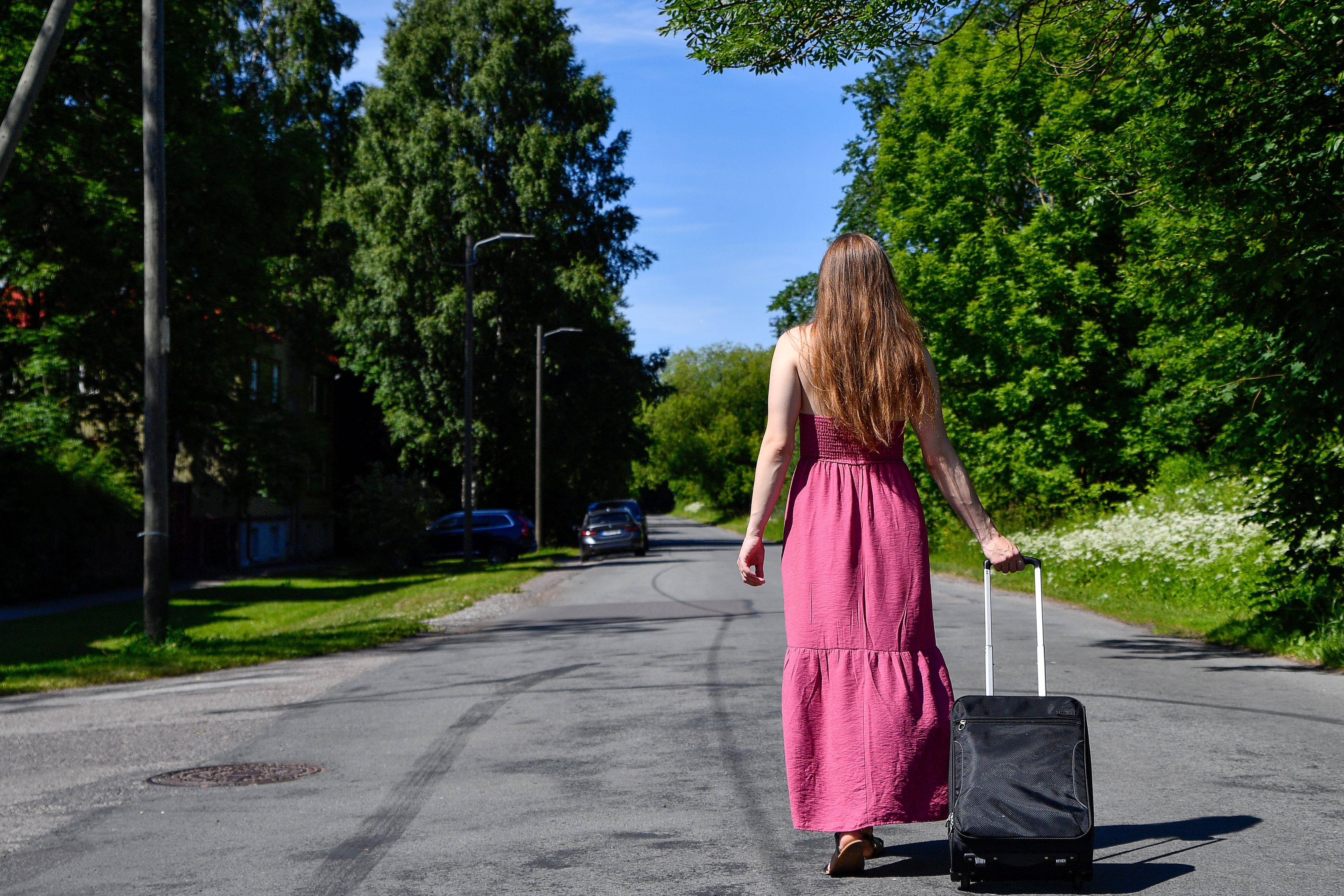 woman walking away street