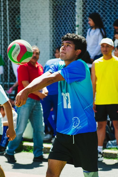 Free Dynamic outdoor volleyball match in Mexico City with a focus on young athlete in action. Stock Photo