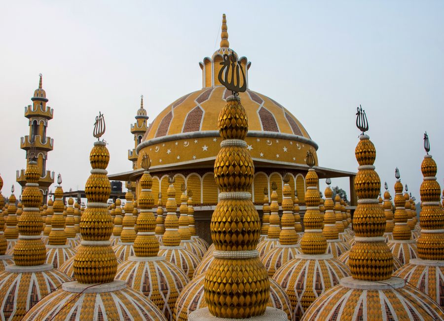 Colorful domes of a mosque with intricate patterns, showcasing unique architecture.
