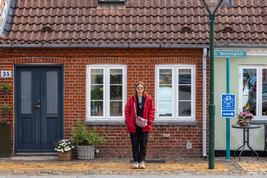 Cozy Danish street with red brick facade and bicycle sign in Middelfart, Denmark.