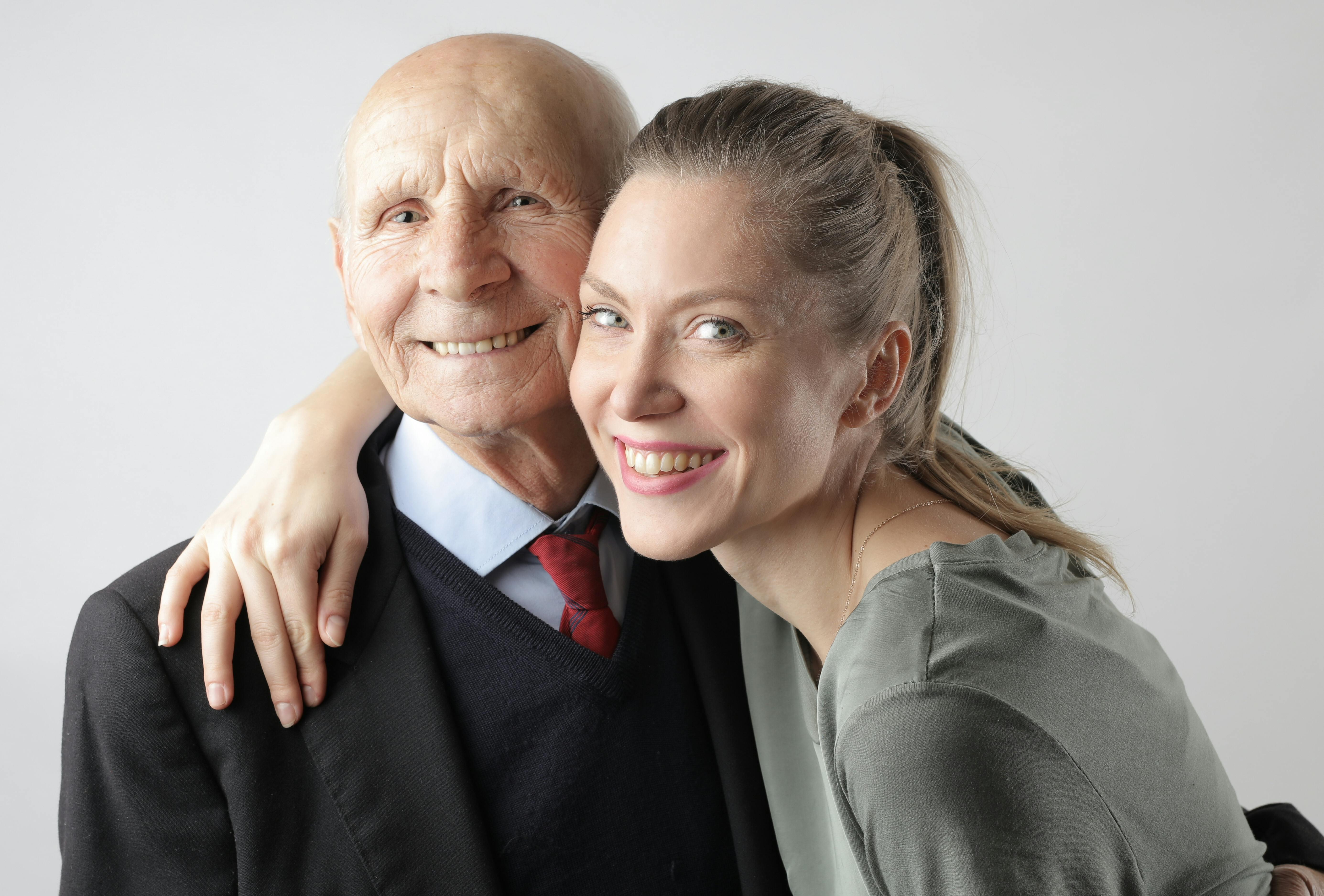 Delighted senior father and adult daughter hugging in studio · Free Stock Photo