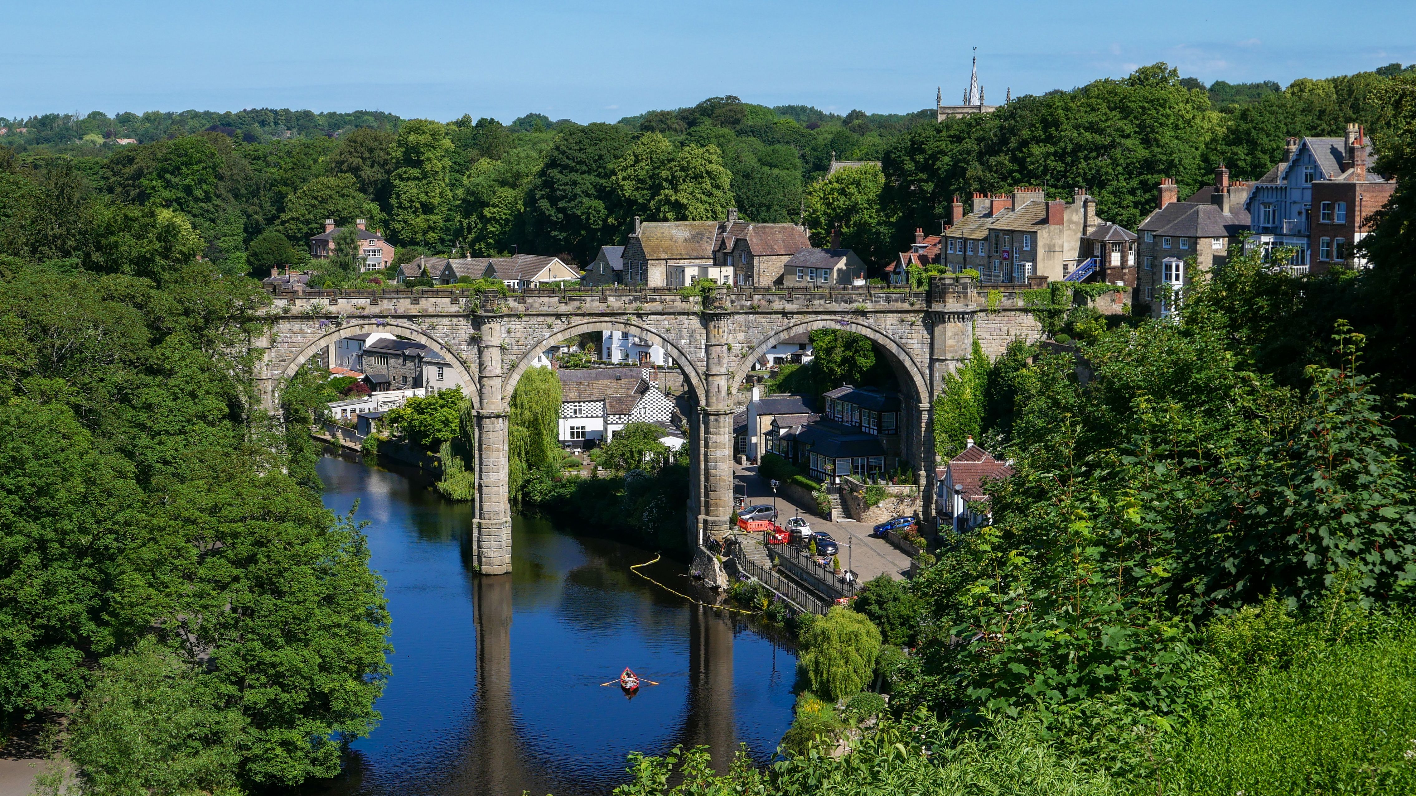 Scenic view of Knaresborough Viaduct and River Nidd on a sunny day in England.