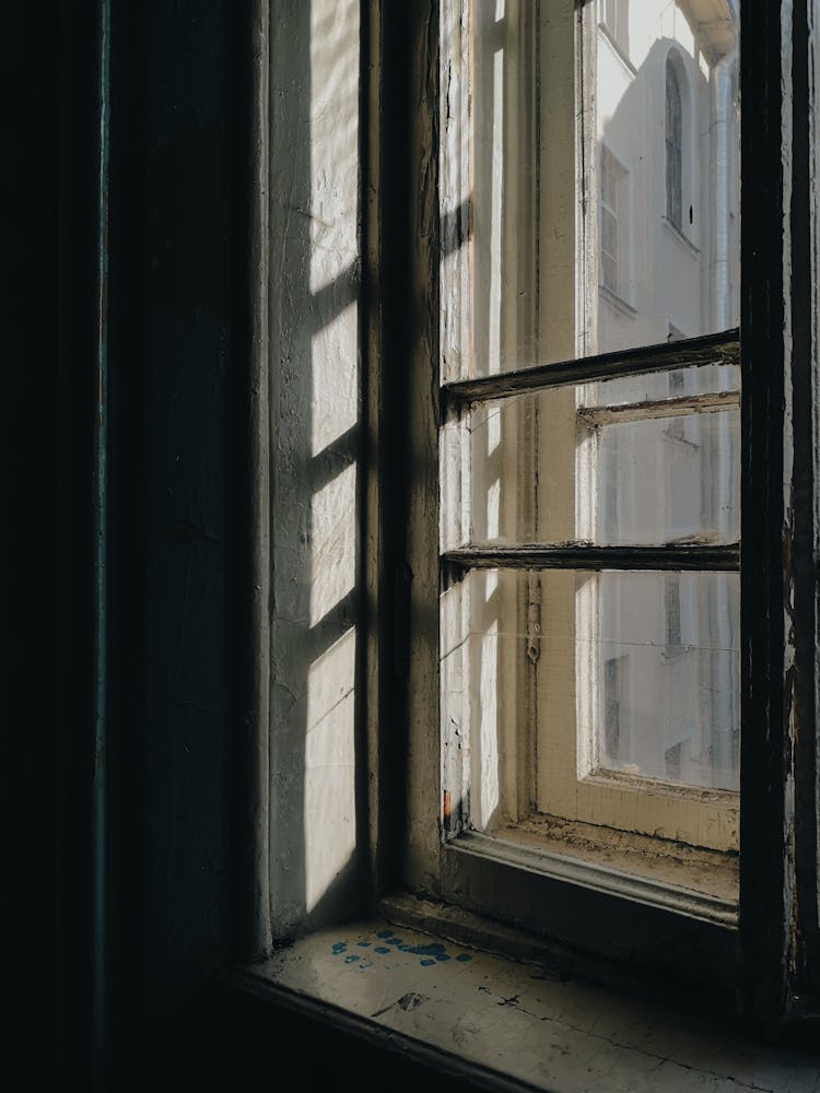 Old Shabby Wooden Window Frame In Dark Room