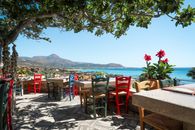 Colorful taverna with ocean views in Phalasarna, Greece. Ideal for summer relaxation.