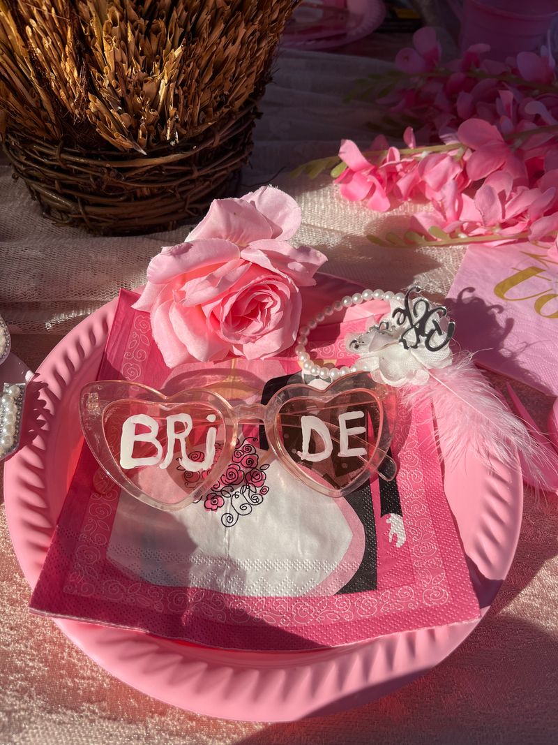 Pink bridal shower table setting with roses and elegant place settings