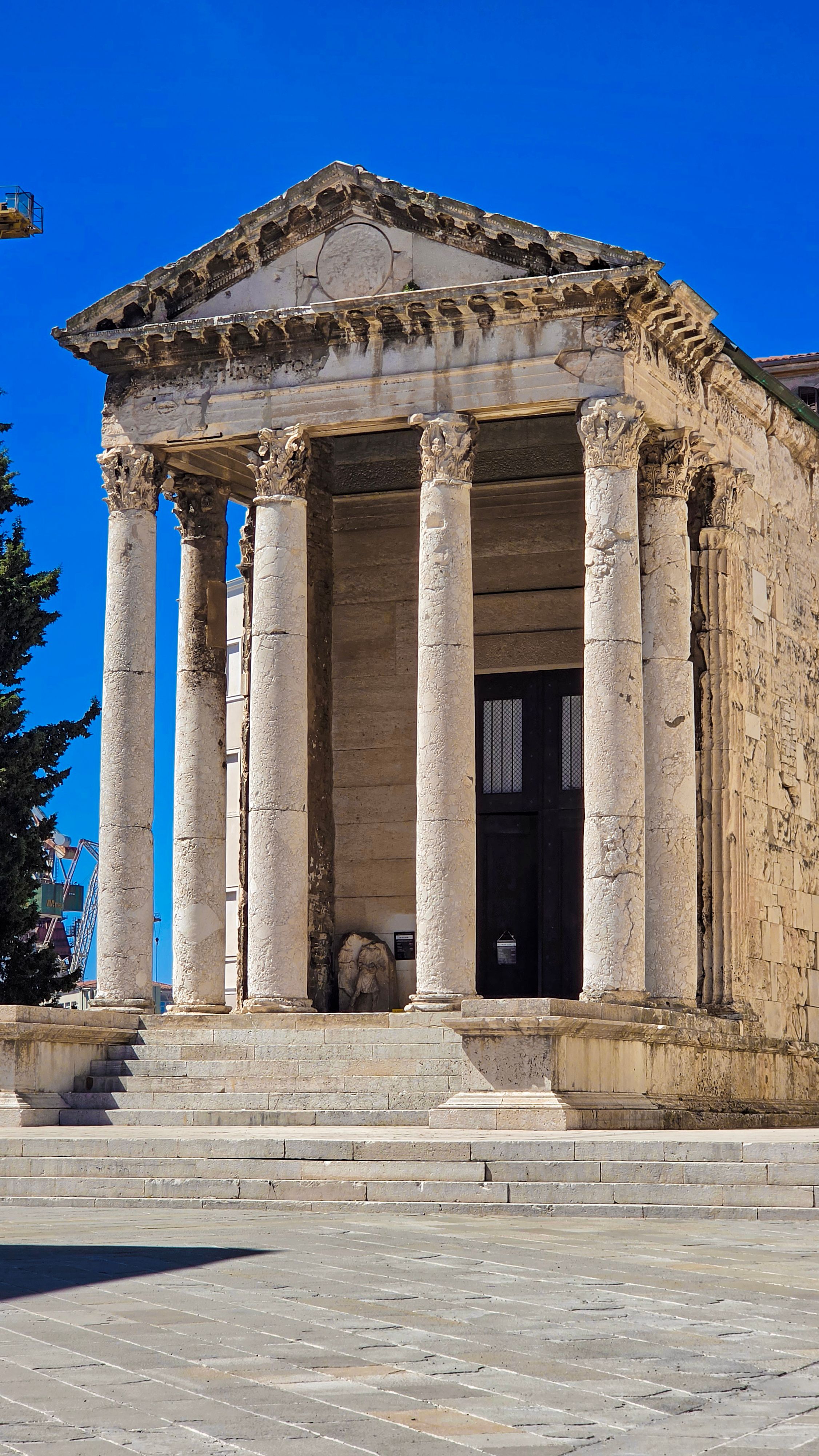 Historic Roman temple in Pula, Croatia with classic architecture and Corinthian columns.