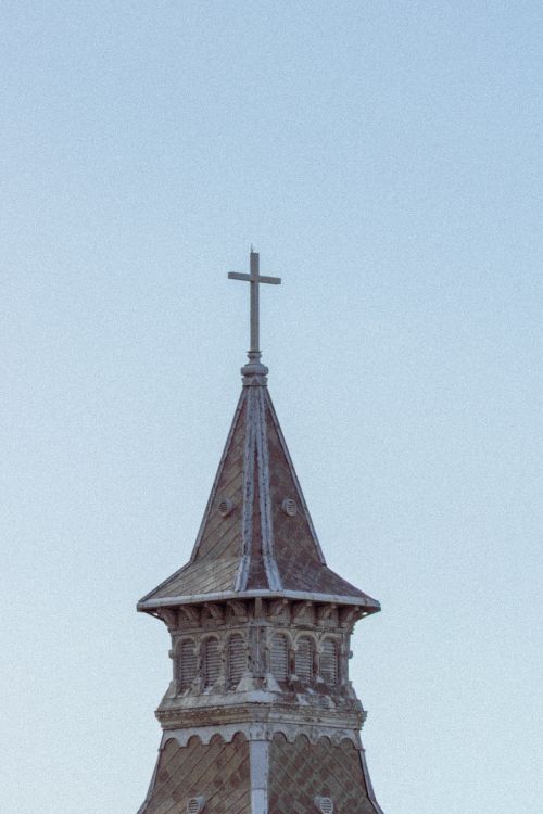 Free A classic church steeple featuring a cross against a clear sky in Mar del Plata, Buenos Aires. Stock Photo