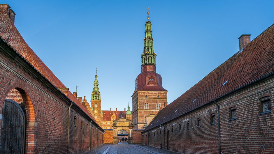 Beautiful Renaissance architecture of Frederiksborg Castle in Denmark under a clear blue sky.