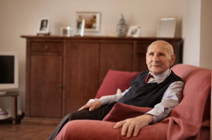 A senior man seated in a warm living room — photo by Andrea Piacquadio on Pexels
