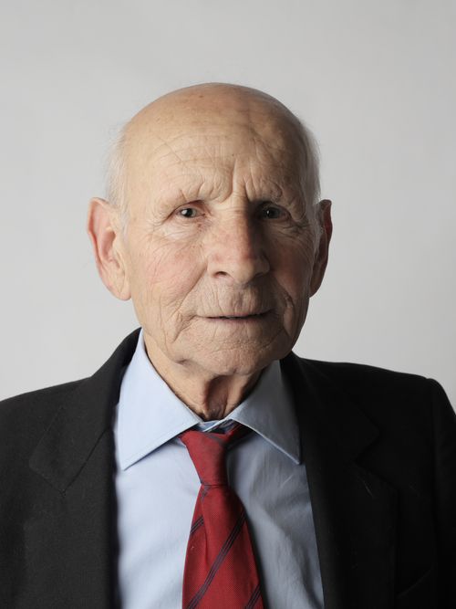 Free A contemplative portrait of an elderly man in formal attire, showcasing a pensive expression. Stock Photo