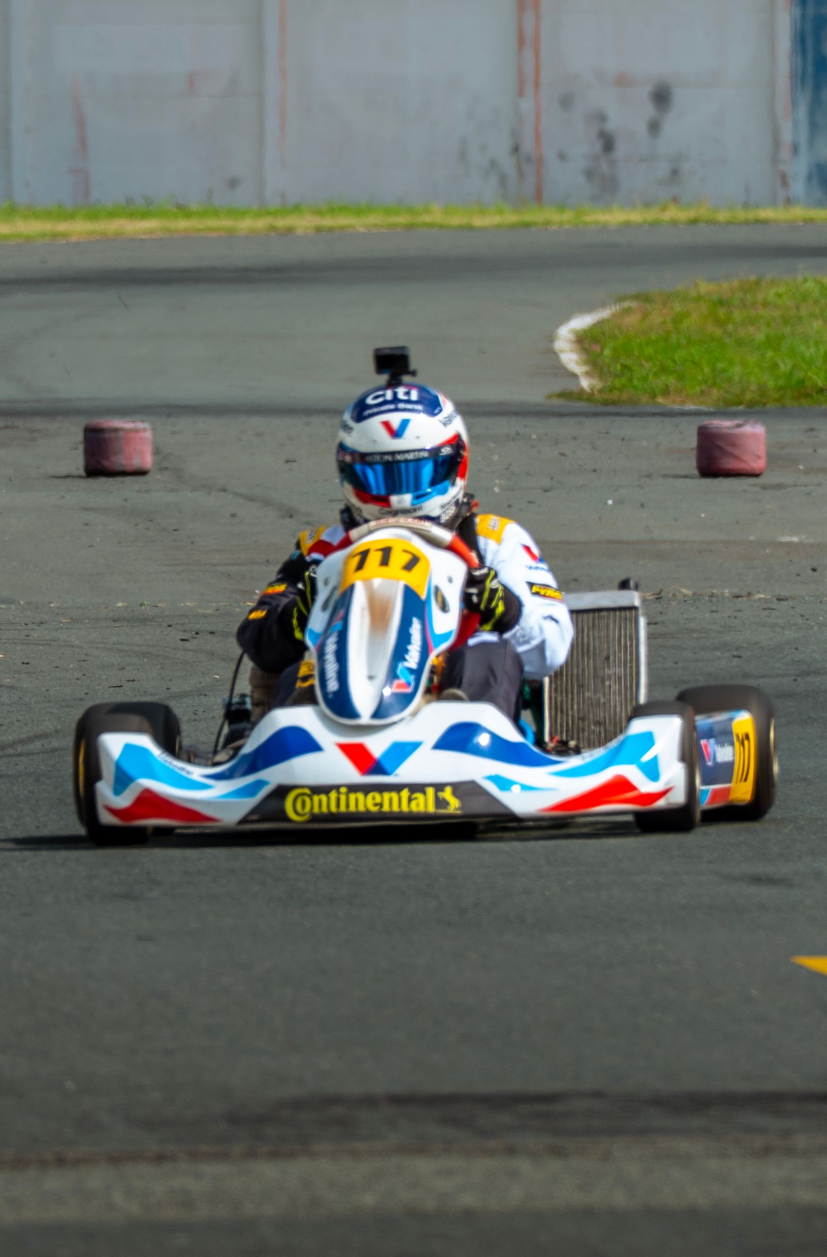 Exciting scene of a go-kart racer speeding on an outdoor track. Perfect for motorsport enthusiasts.