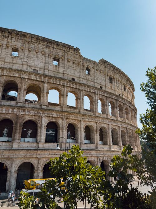 Free Capture of the ancient Colosseum under a bright blue sky in Rome. Stock Photo
