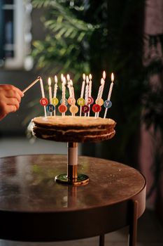 A beautifully decorated birthday cake with lit candles ready for celebration.