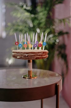 Celebrate with a classic birthday cake adorned with vibrant candles on a decorative table.