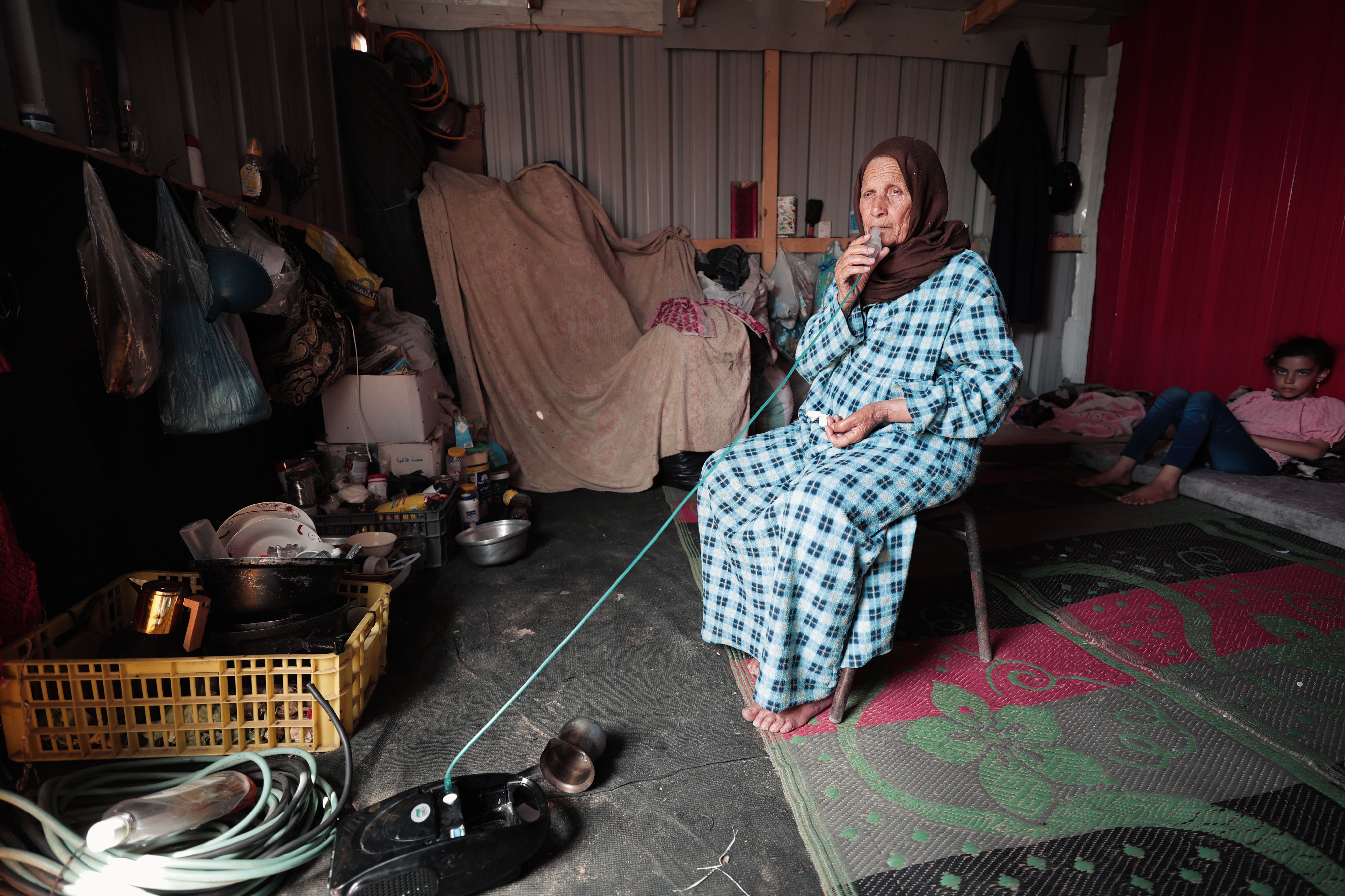 Woman in Modest Home Interior with Family · Free Stock Photo