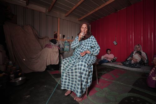 Free A family inside a modest shelter reflecting everyday life and resilience. Stock Photo